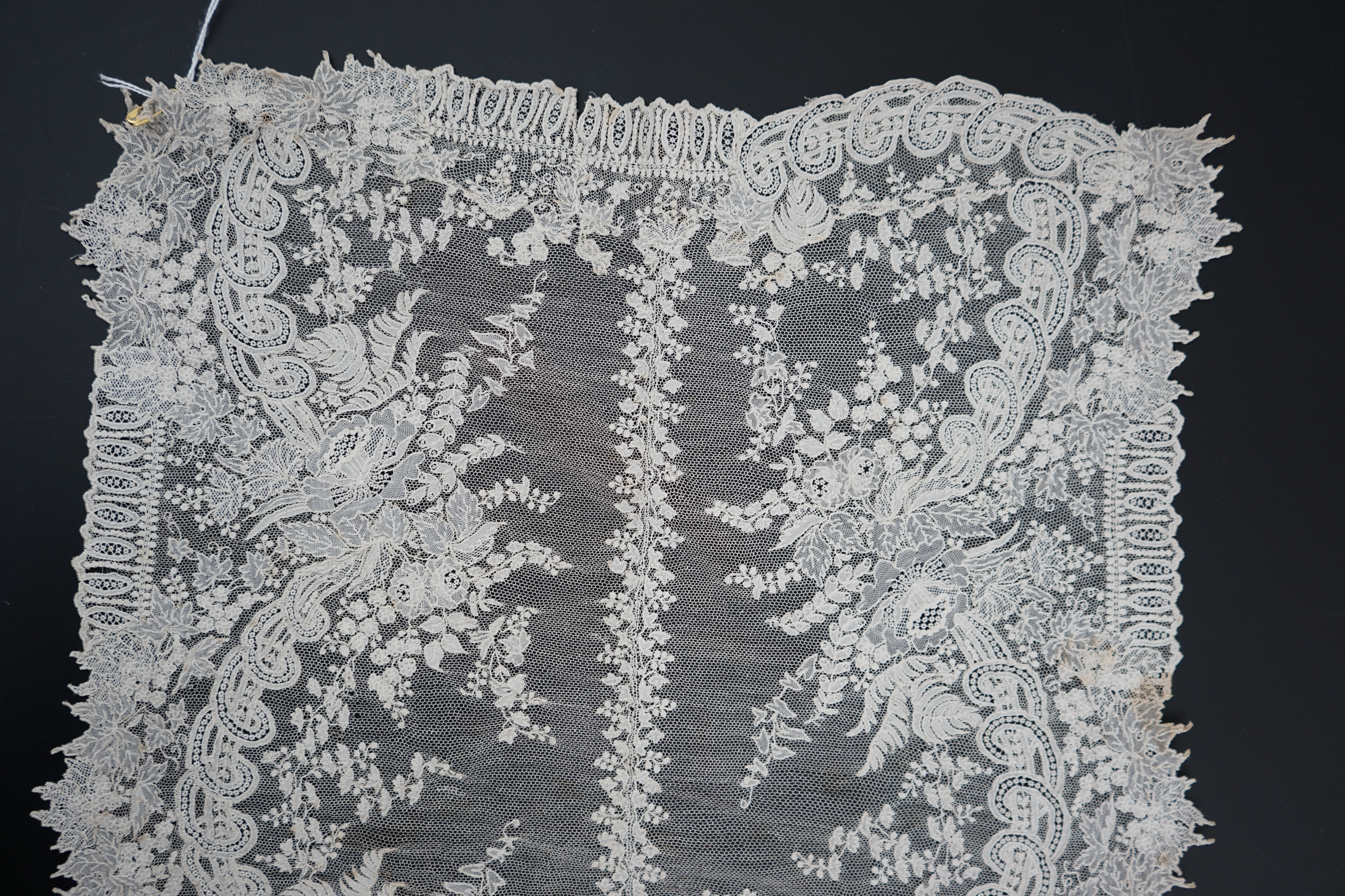 A 19th century Brussels Point de gaze needle lace stole 228cm long x 37cm wide, made from two lengths of the same patterned lace, invisibly joined along the centre of the stole, the raw end edges carefully finished with